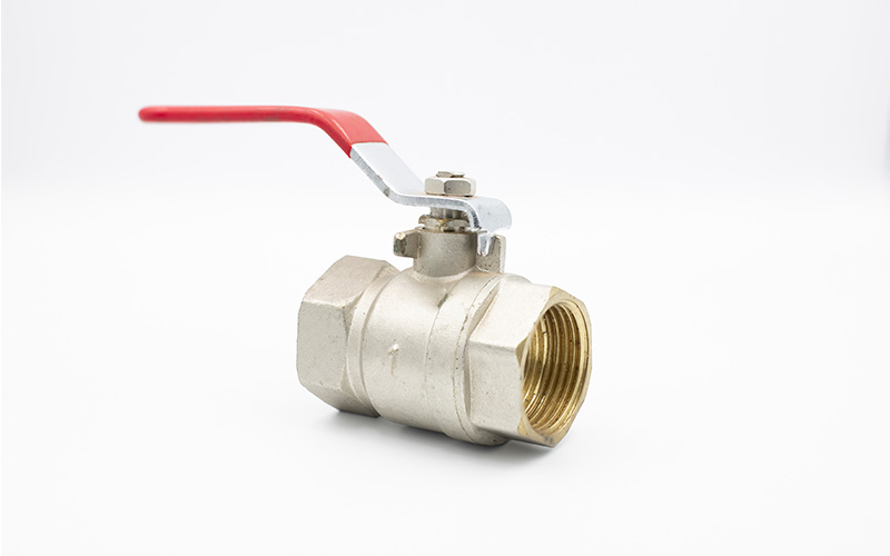 A brass ball valve with a red lever handle shown against a plain white background