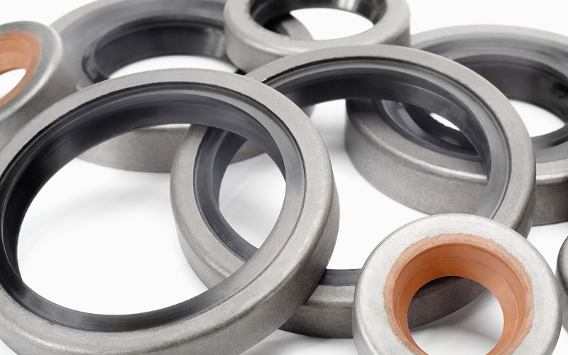 Assorted industrial oil seals and circular gasket materials.