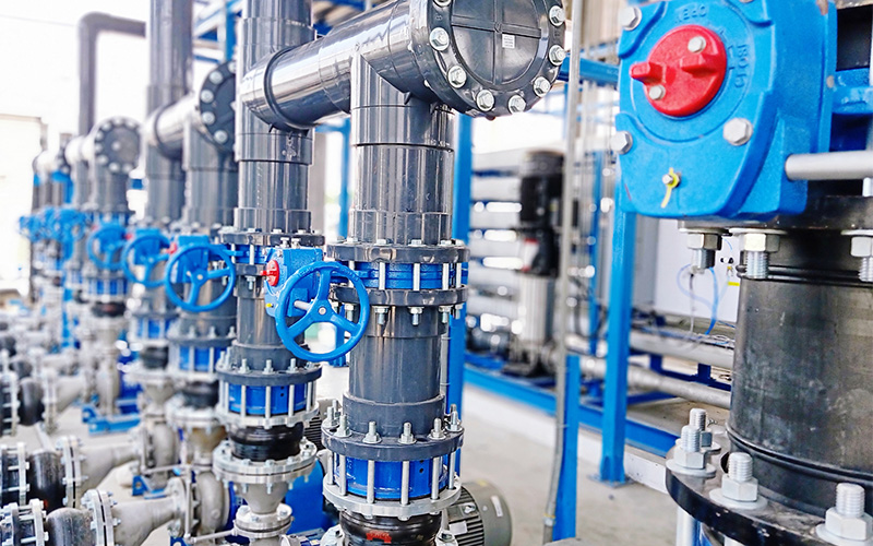 Close-up of blue manual valves in a fluid control system