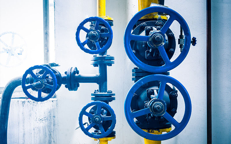 Industrial blue butterfly valve components in a piping system.