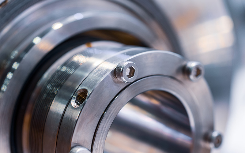 Mechanical Flange Assembly A close-up of a heavy-duty industrial metal flange assembly secured with multiple hexagonal bolts.