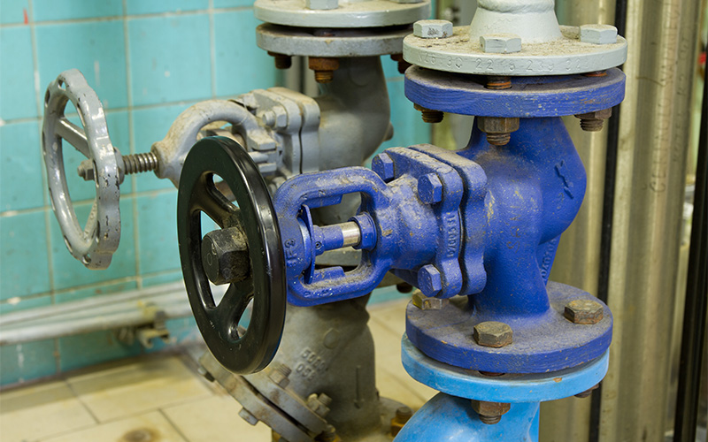 Pipes and faucet valves of heating system in a boiler room